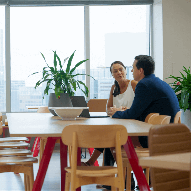 A conversation between Macroplan colleagues in the office